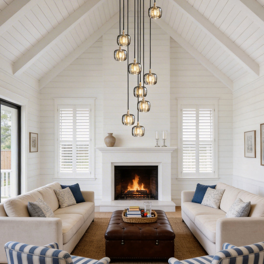 Staircase crystal chandelier with multiple lights, illuminating a cozy living room.