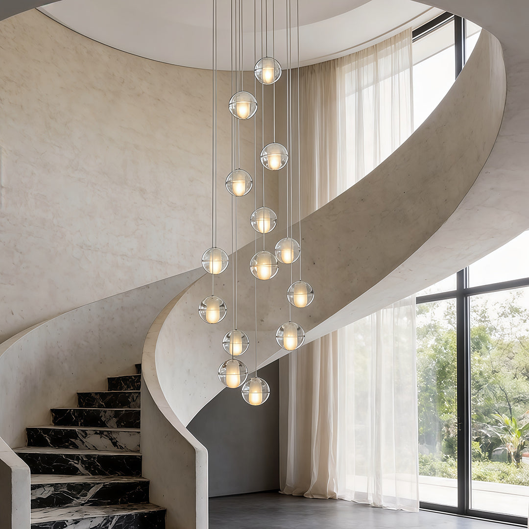 Staircase hanging chandelier providing elegant light above a spiral staircase.