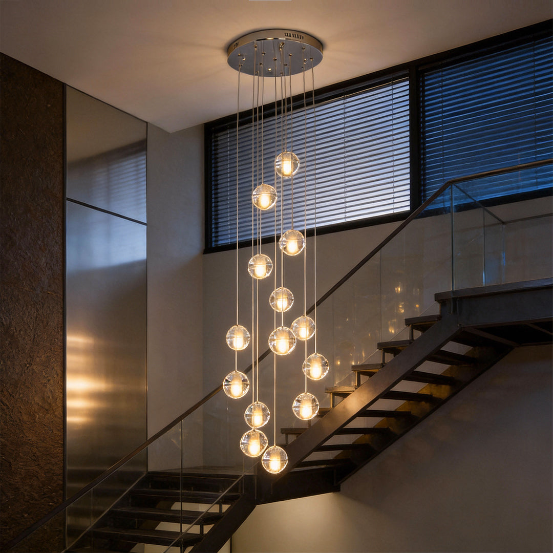 Staircase hanging chandelier illuminating a modern staircase with warm, cascading glow.