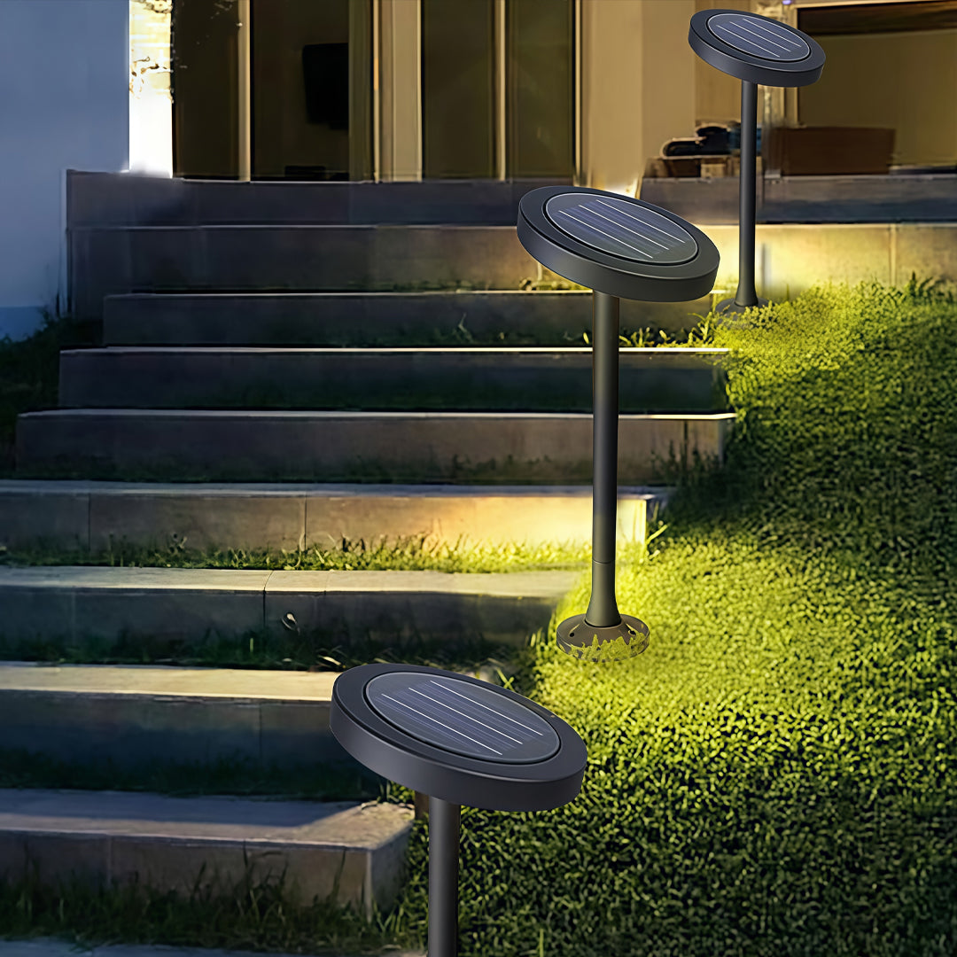 Outdoor staircase illuminated with contemporary path lights outdoor featuring round LED heads.