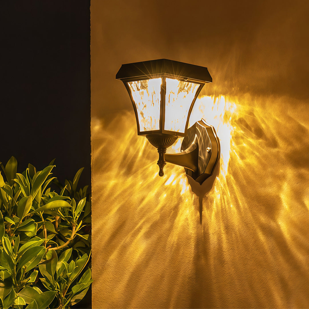 Beautiful starburst light pattern projected from the solar outdoor sconce lights on a dark wall.