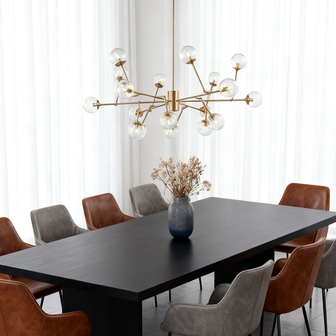 Bubble sputnik chandelier serving as a statement focal point in a crisp white dining room with floor-to-ceiling black frame windows.