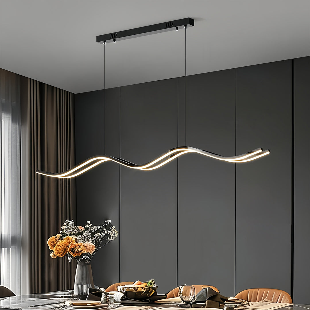 Statement black kitchen island pendant light providing focused illumination above a dining table in a dark, contemporary setting.