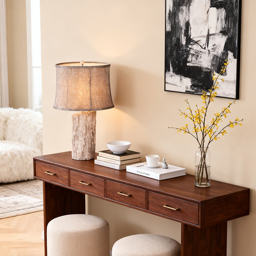 White wood table lamp as a statement piece on a dark brown console table with a minimalist black and white abstract painting backdrop.