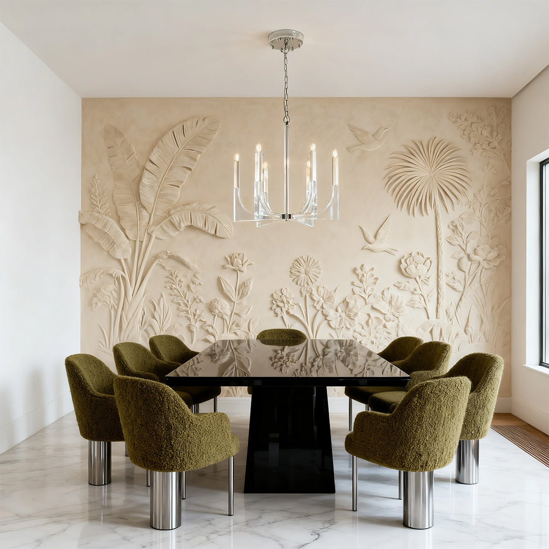 Statement retro chandeliers with sleek candle arms illuminating a modern dining table set against a dramatic botanical relief wall.