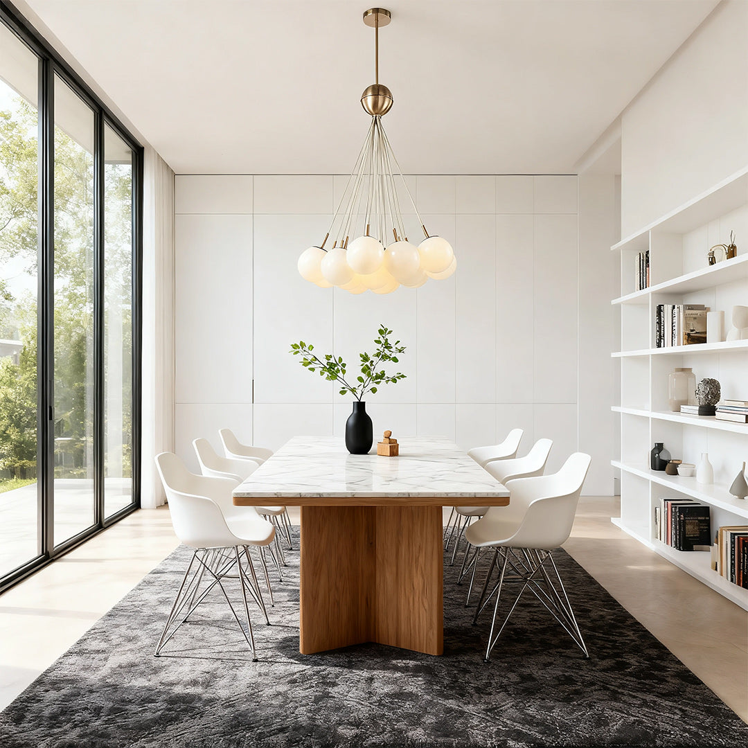 Statement bubble glass chandelier suspended above a wood and marble dining table, complementing a minimalist room with tall windows.