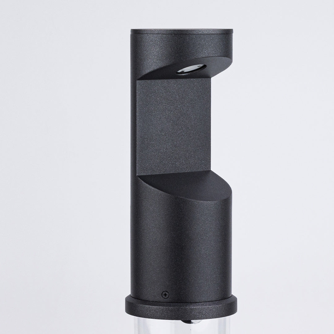 Modern cylindrical outdoor light with stepped geometric profile and dark finish