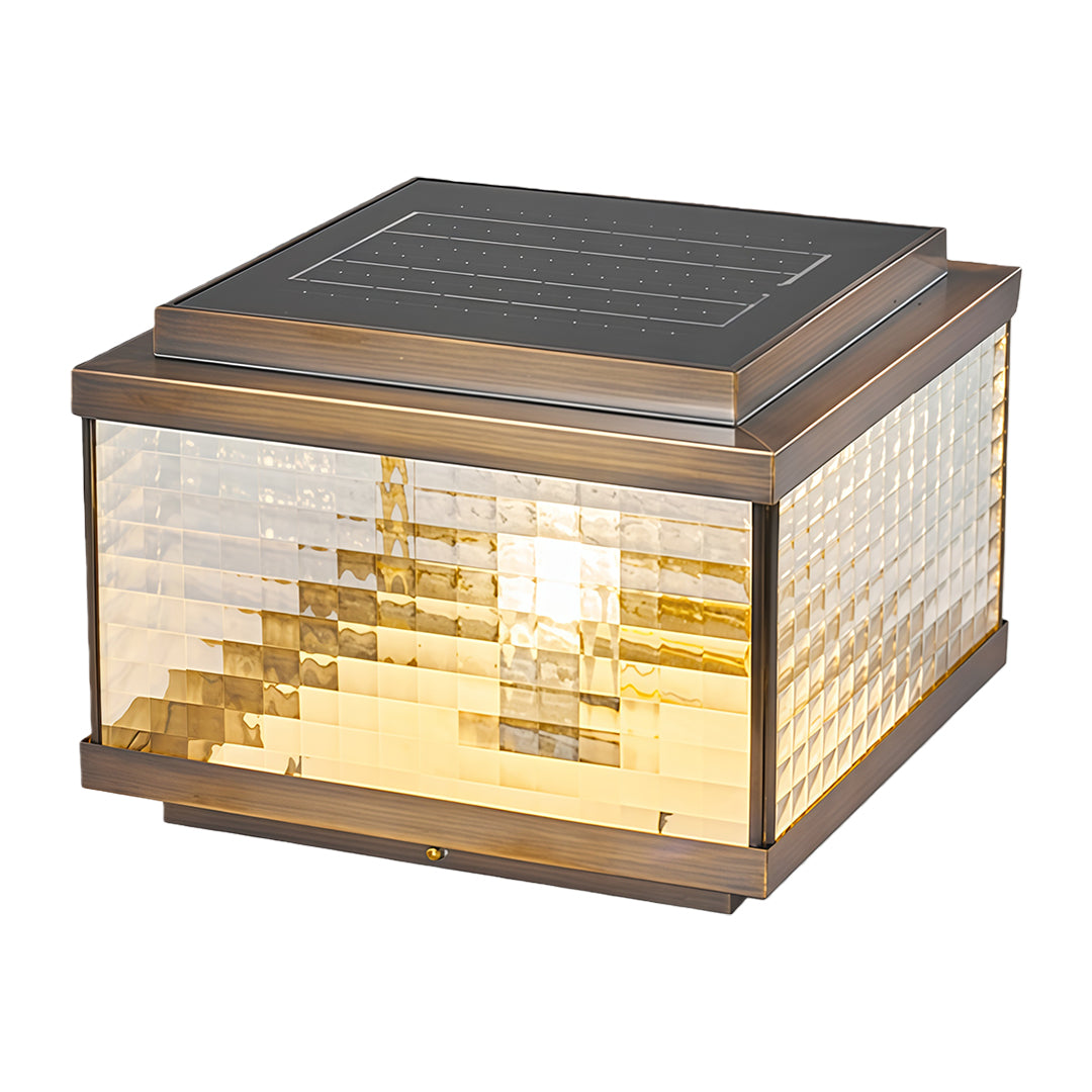 Decorative pillar cap light with stepped glass pattern emitting soft warm glow for entrance areas