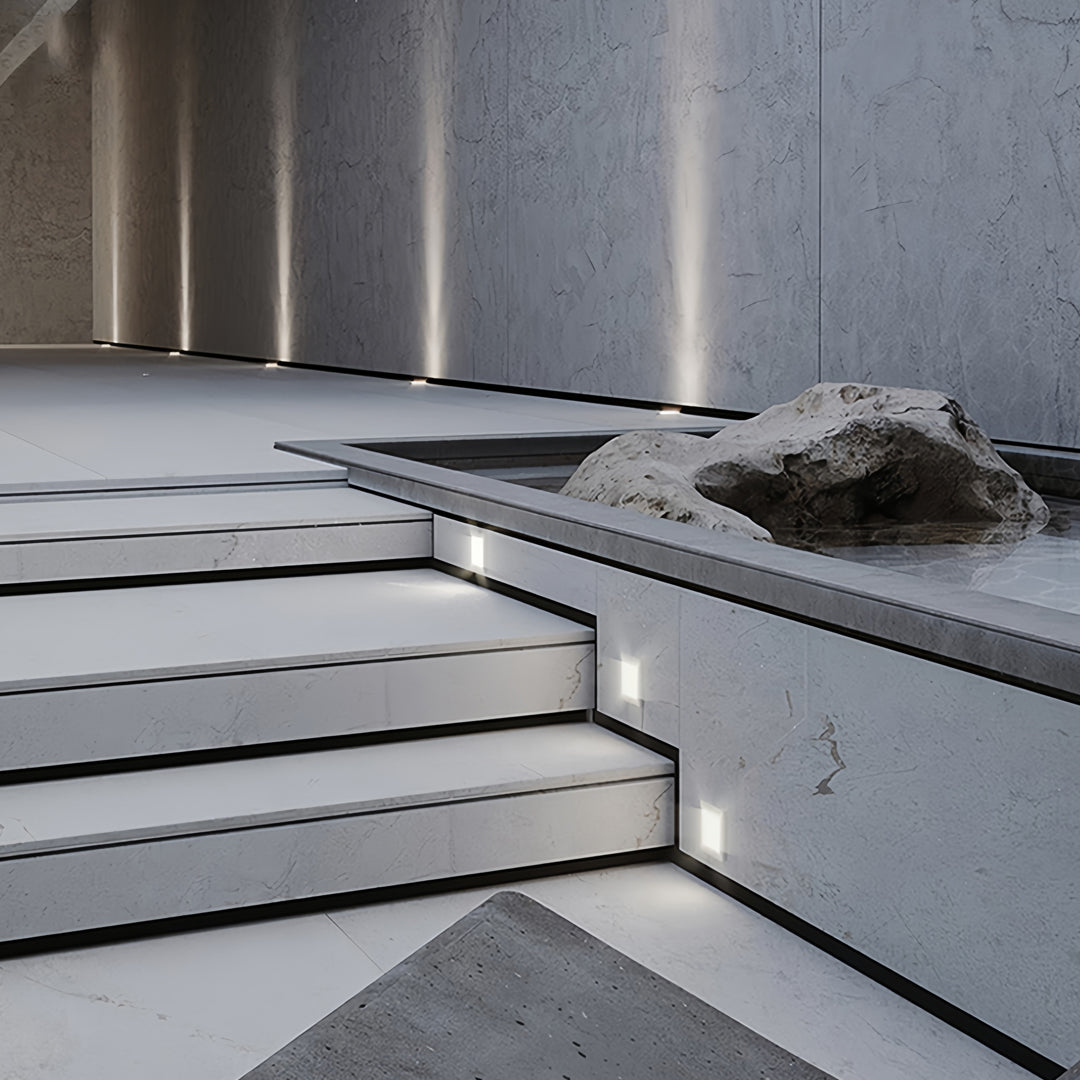 Contemporary exterior steps accented with linear and square outdoor inground lighting fixtures.