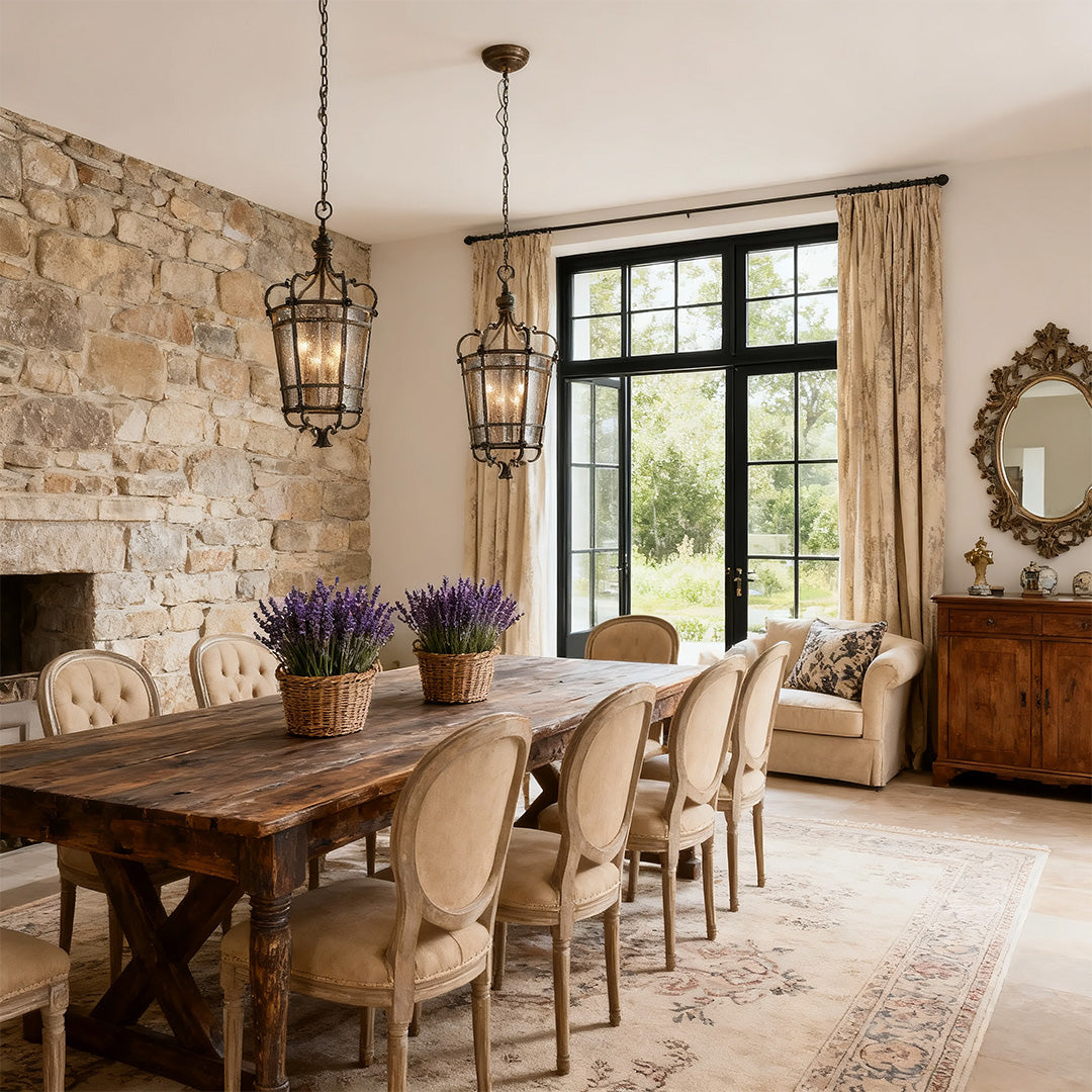 Italian pendant light fixture centered over a long dining table, complementing a stone accent wall and large, elegant window coverings.