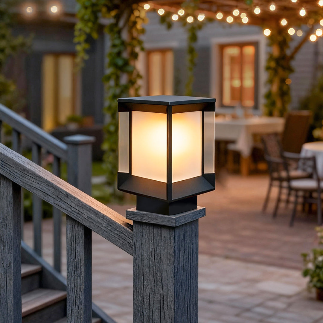 Pillar lights outdoor modern mounted on a stone pedestal in a patio garden.