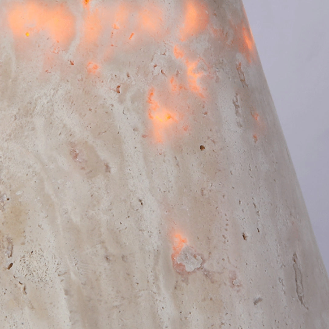 Close-up of down light wall sconce showing the translucent stone shade and warm glowing texture.