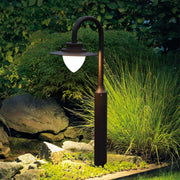 Natural stone garden setting showcasing shepherd's hook lights among lush green vegetation