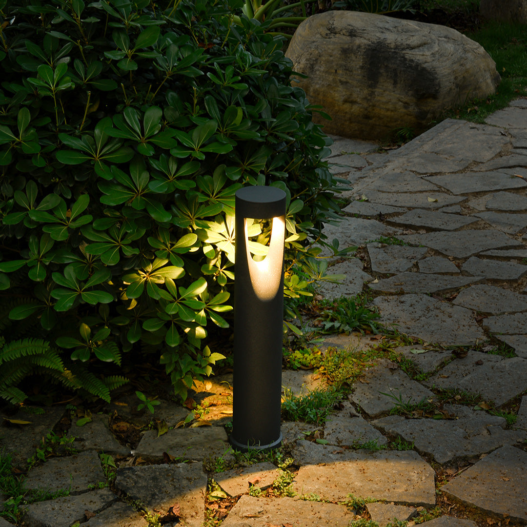 Natural stone landscape with bollard lighting providing directional illumination among rock features