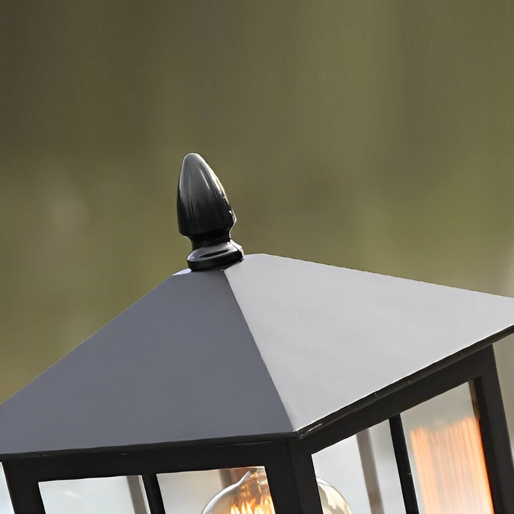 Close up of a stone light pillar with a black lantern, showcasing its vintage design.