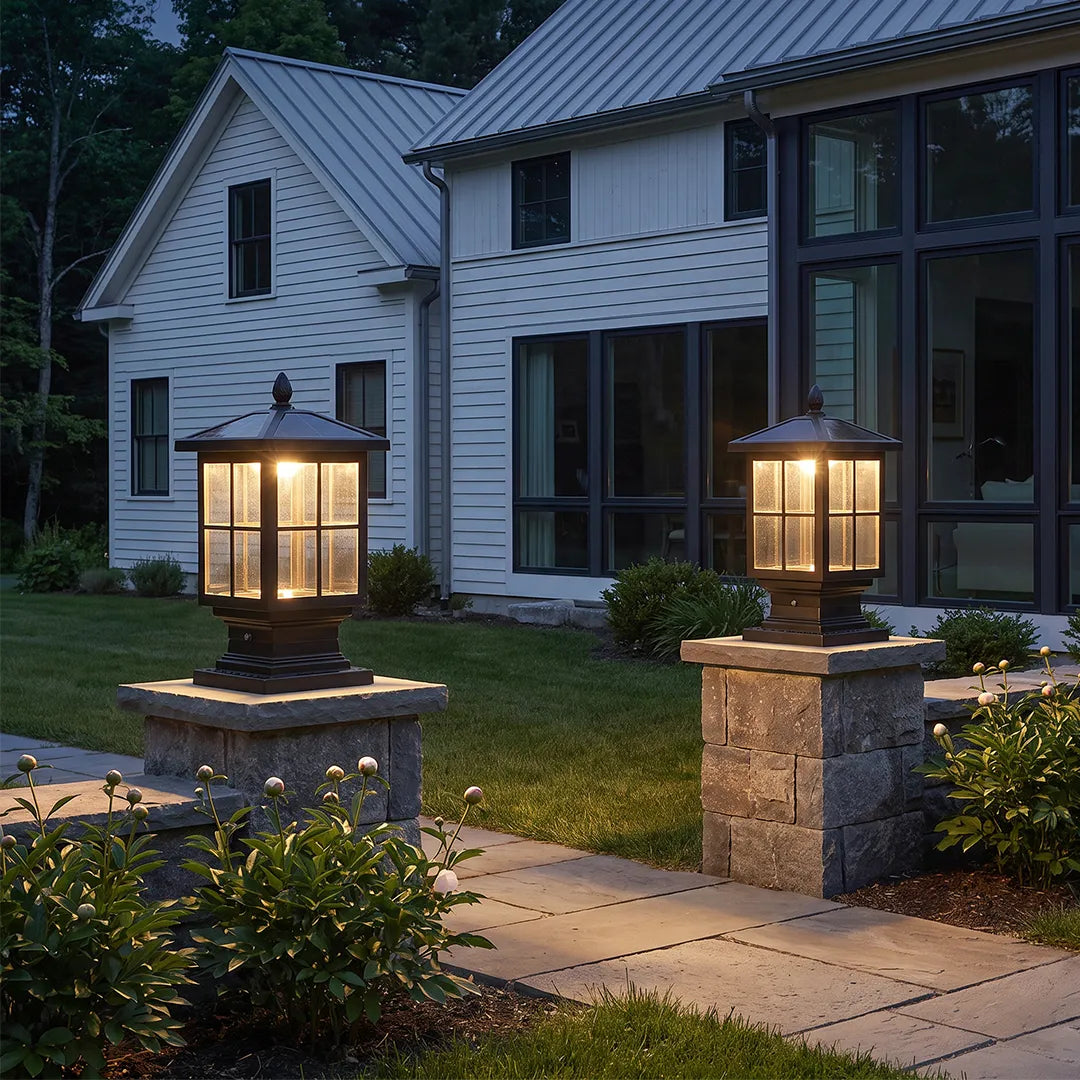 Stone light pillars arranged on entry columns along a modern front walkway with black lantern fixtures.