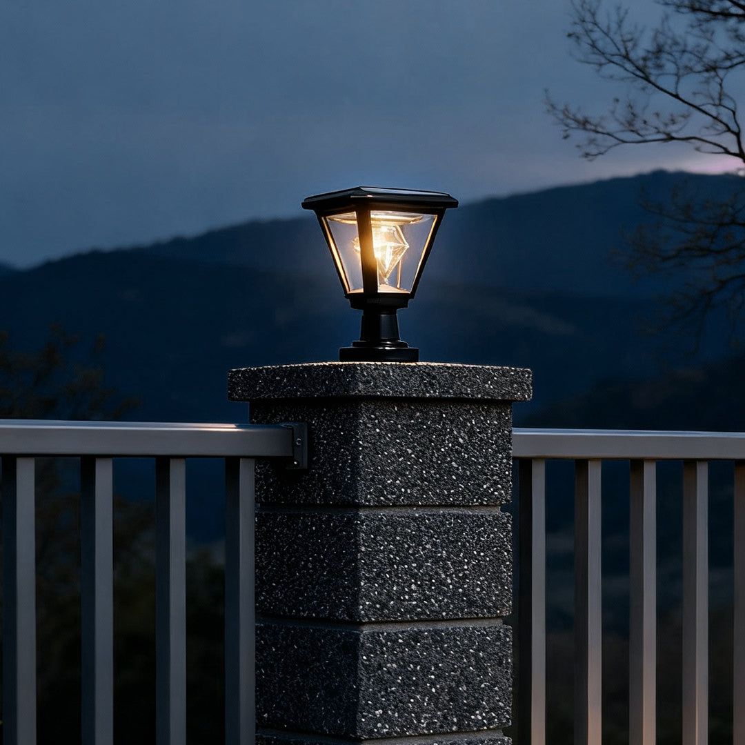 Nighttime scene of stone pillar topped with led post cap lights providing a decorative and functional outdoor glow.