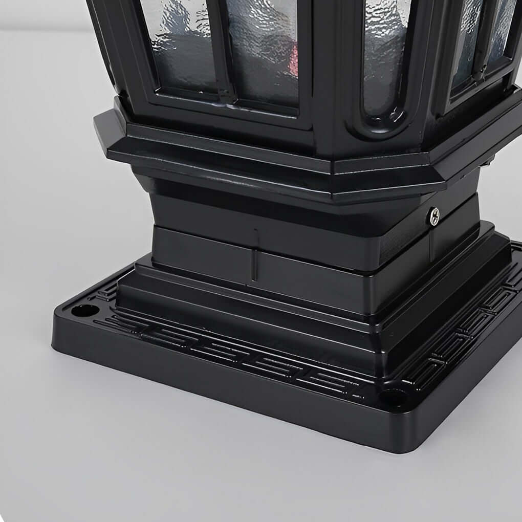 Close-up of black stone pillar light fixture base showing mounting holes and solid construction.