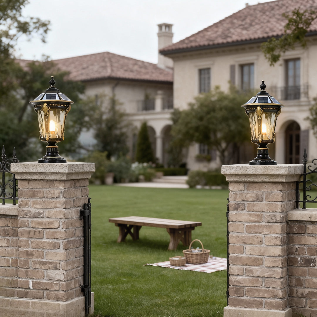 Stone pillar lights on a brick pillar, enhancing the driveway with warm and inviting light.