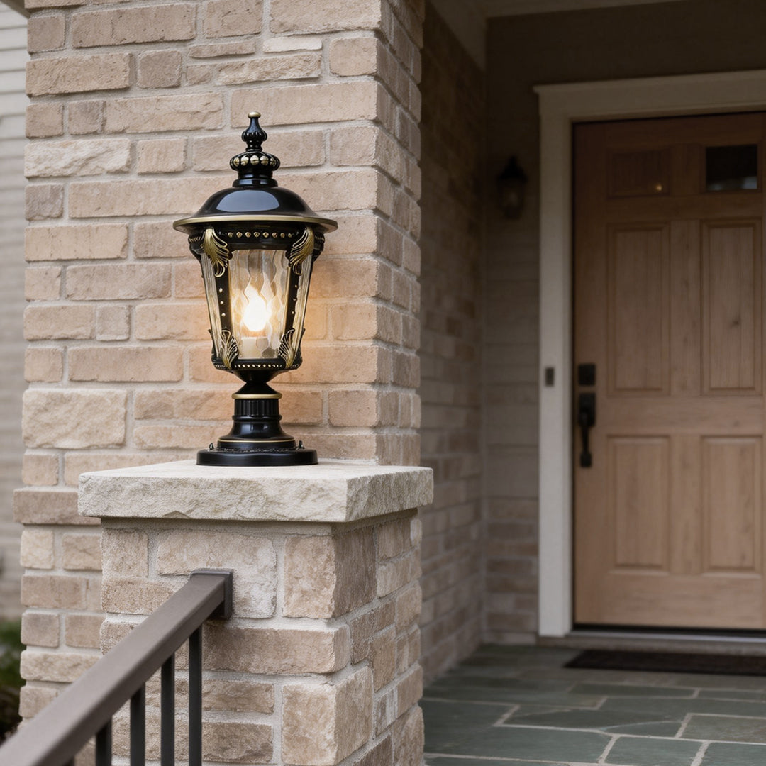 Stone pillar lights in a garden setting, casting a soft glow on the manicured lawn.