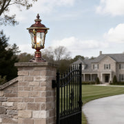 Stone pillar lights installed at the entrance of a luxurious estate, providing classic and elegant illumination.