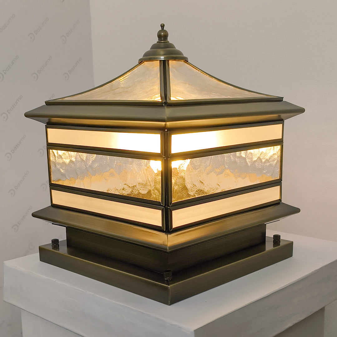 Bronze finish stone pillar solar light displayed on a pedestal for product showcase.