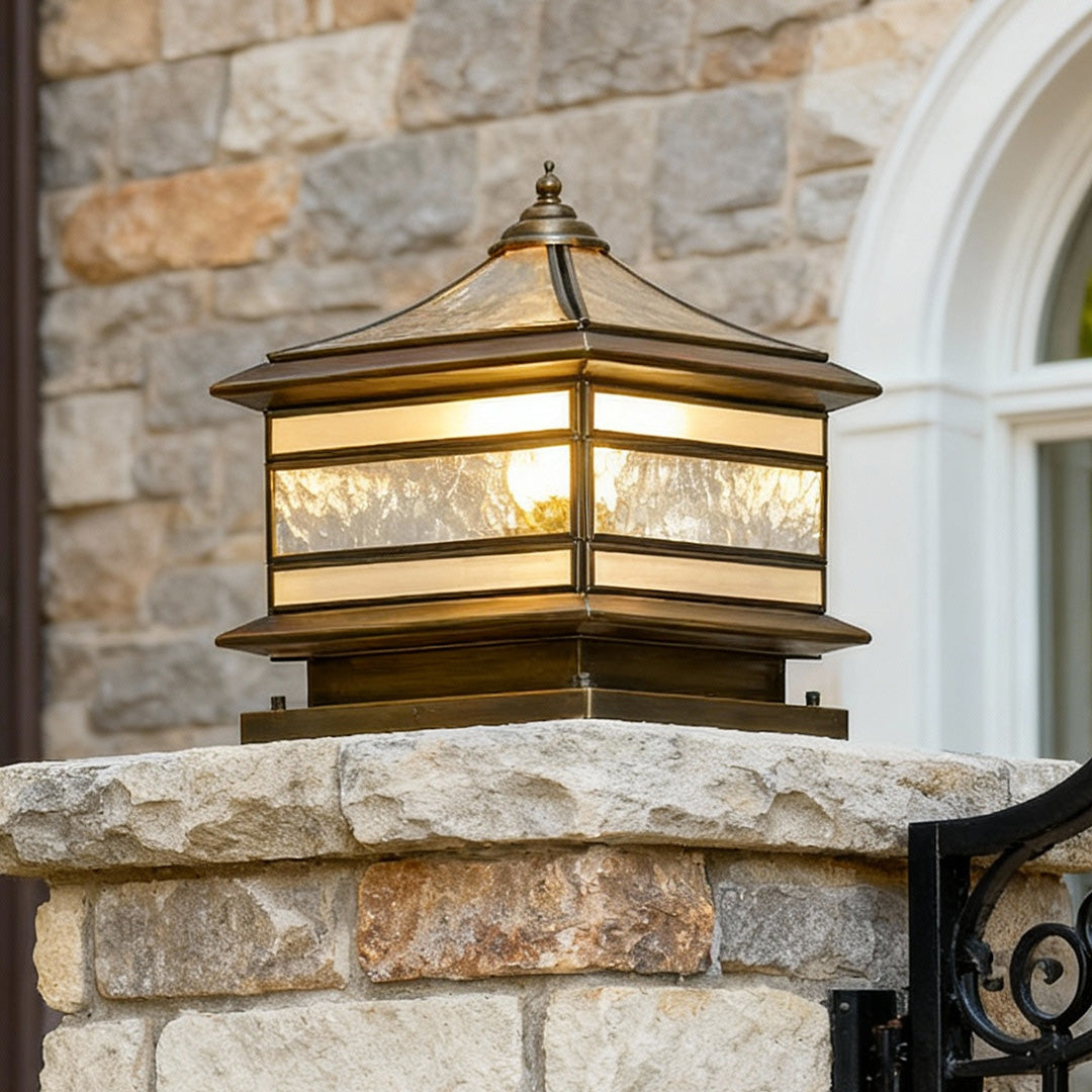 Outdoor stone pillar solar light mounted on a masonry post near an entryway.