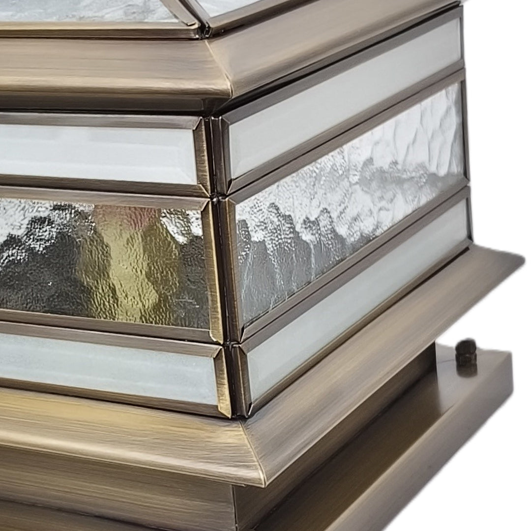 Detailed view of textured glass panel on stone pillar solar light housing.