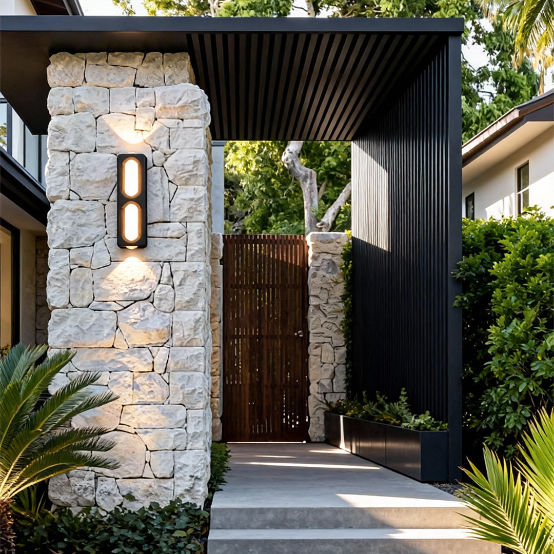 Contemporary unique outdoor wall lighting installed on a stone pillar, enhancing the garden walkway.