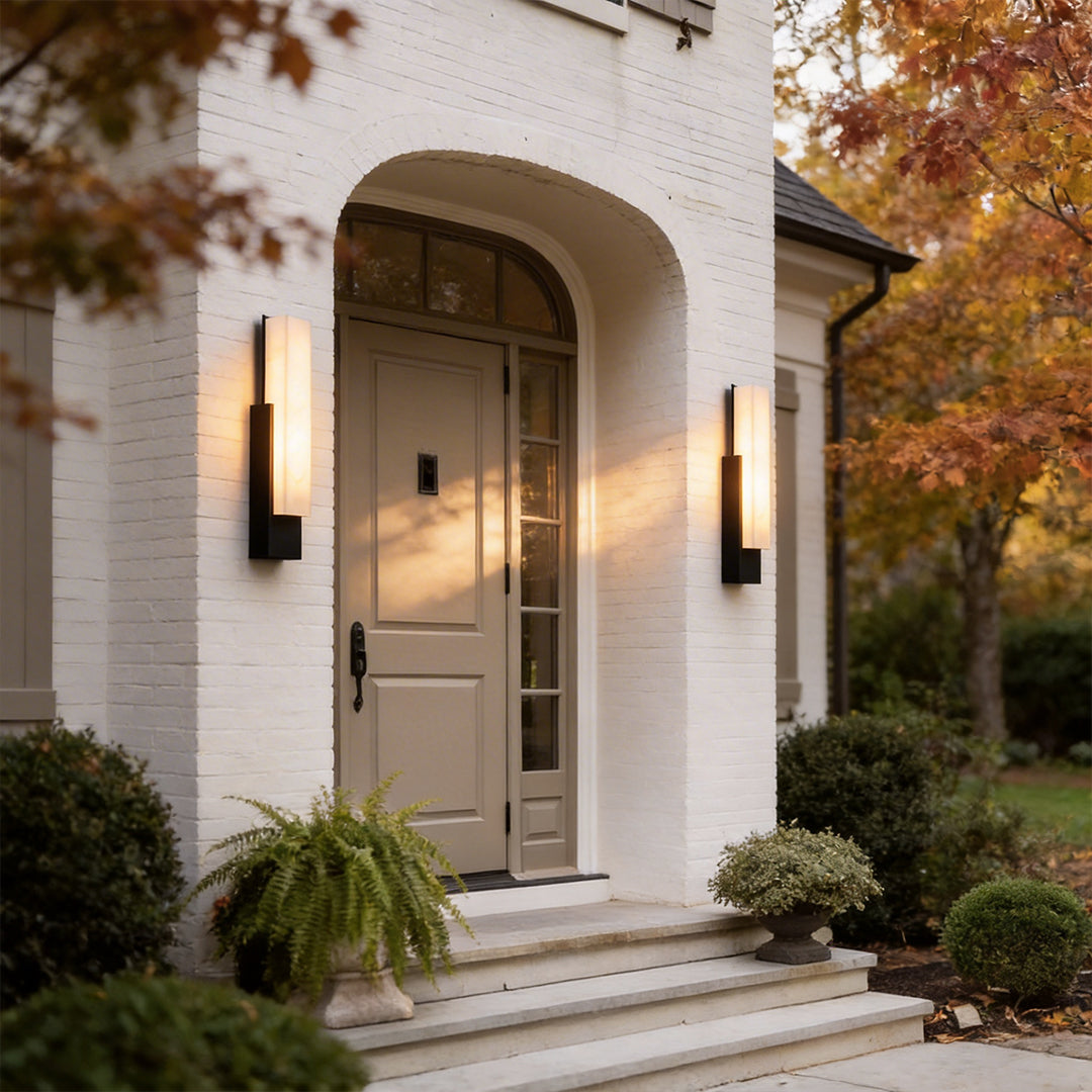 Stone texture wall light with a black frame, enhancing a classic white archway.