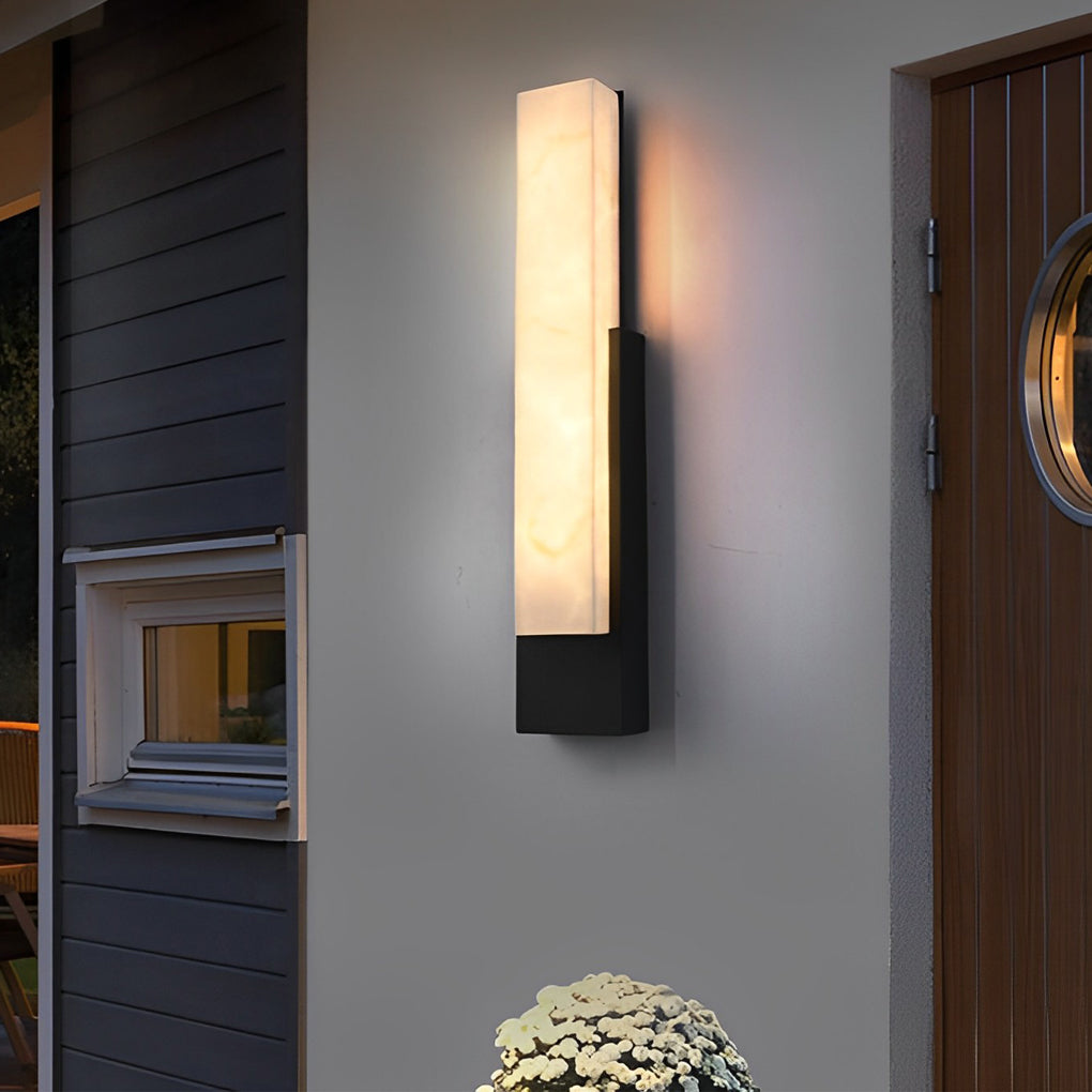 Stone texture wall light with a close-up of its glowing light and stone-like finish.