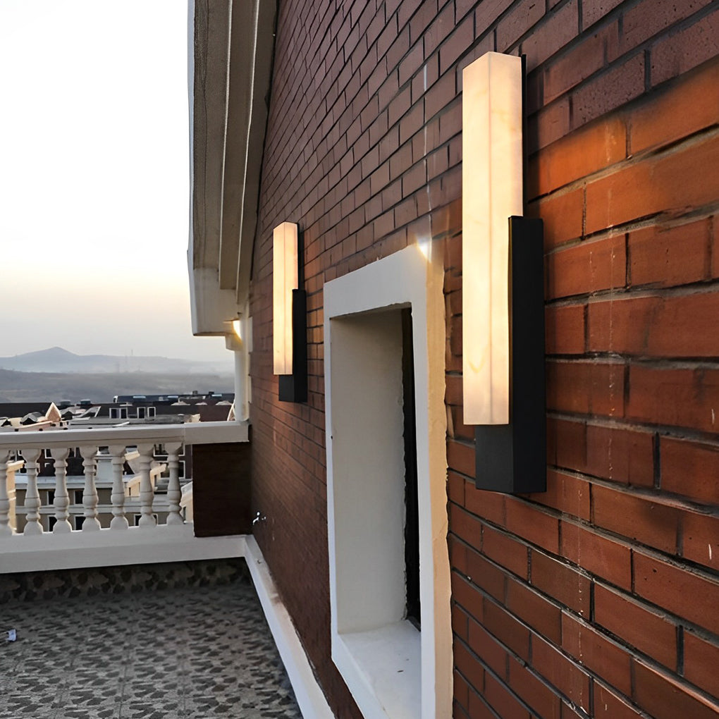 Stone texture wall light with a modern design, illuminating a contemporary exterior wall.