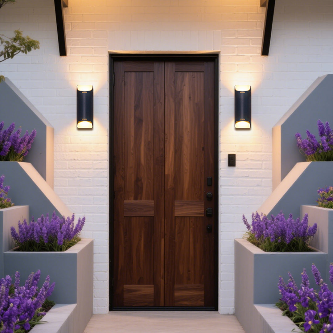 Dramatic stone wall lighting with black cylindrical fixture creating striking upward and downward illumination