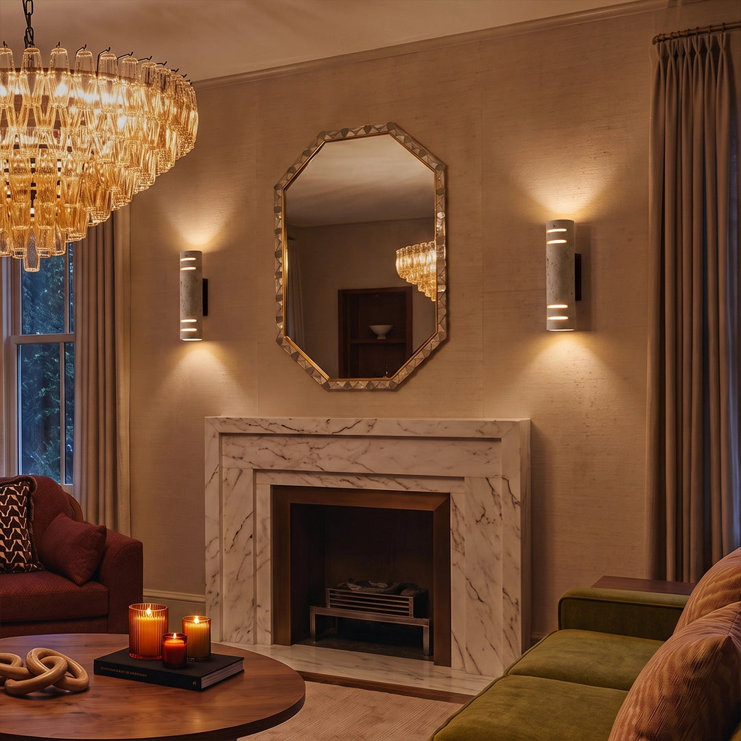 Stone wall light installed beside a fireplace and mirror, adding warm ambient lighting to an elegant living room.