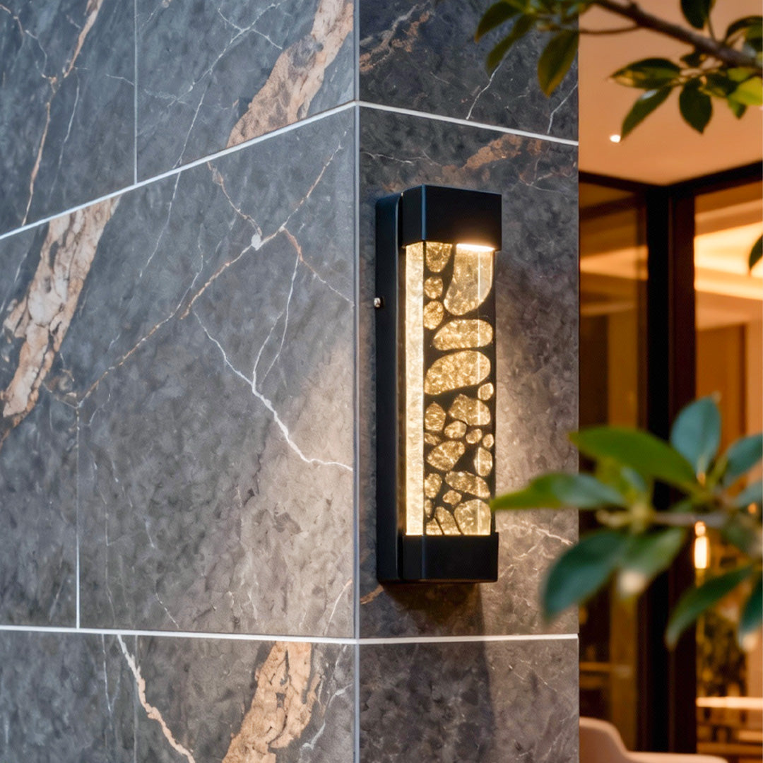 Modern led linear wall light mounted on a dark stone exterior wall, casting warm and elegant illumination.