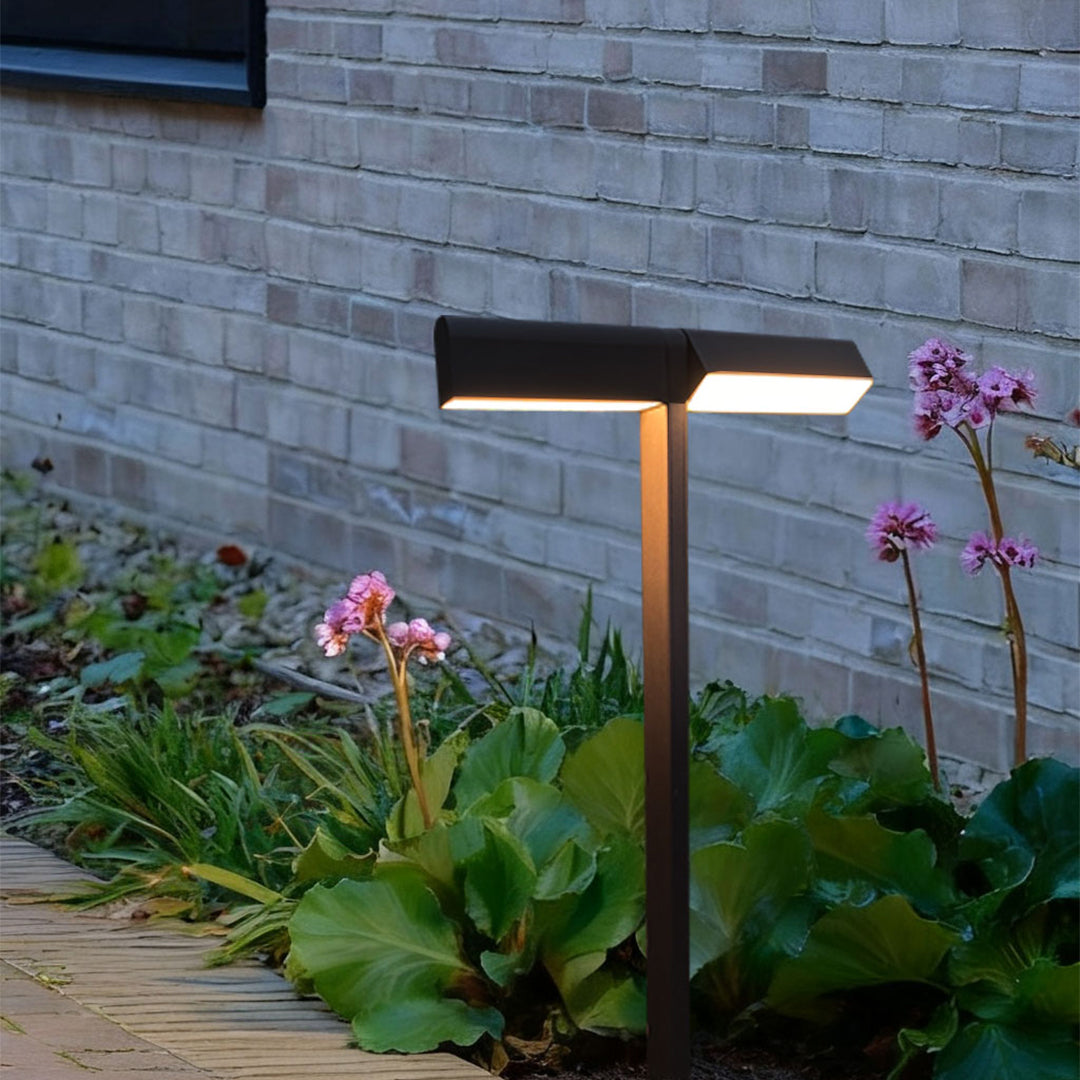 Rectangular-head pathway light mounted beside a stone wall, providing focused illumination for led pathway lighting.