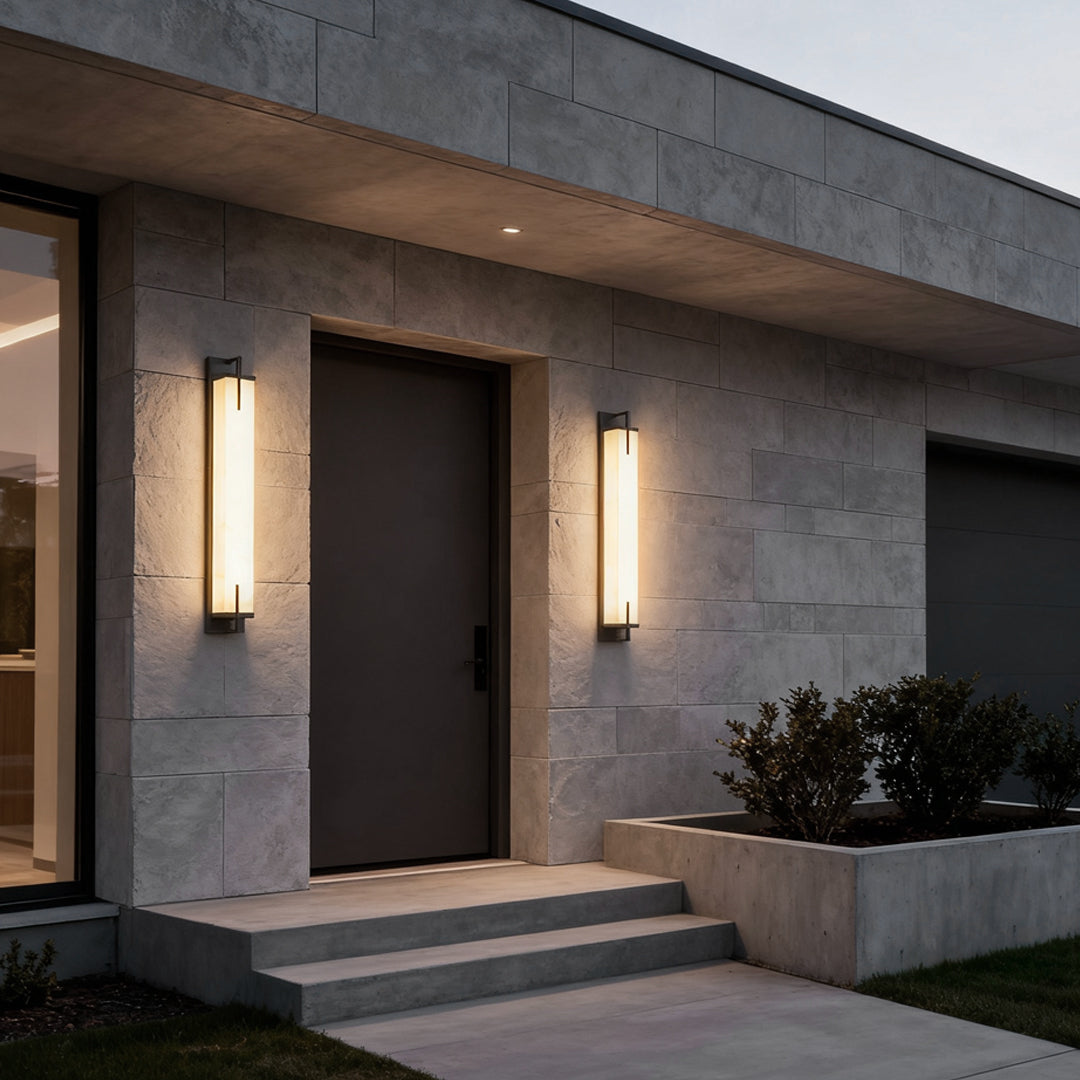 Stone wall sconce lighting enhancing the entrance of a contemporary house with warm light.