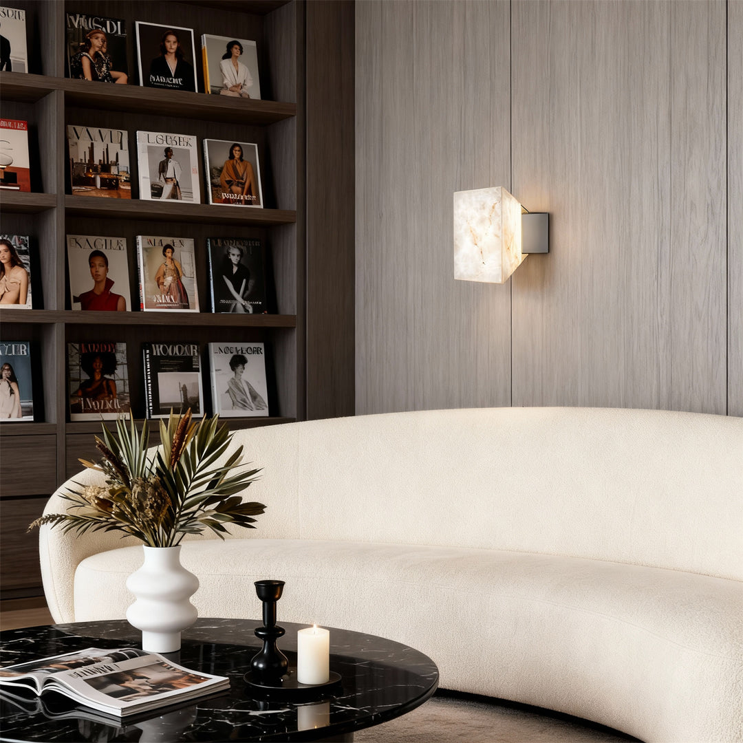 Stone wall sconce lighting providing soft ambient illumination in minimalist bedroom with contemporary gray decor