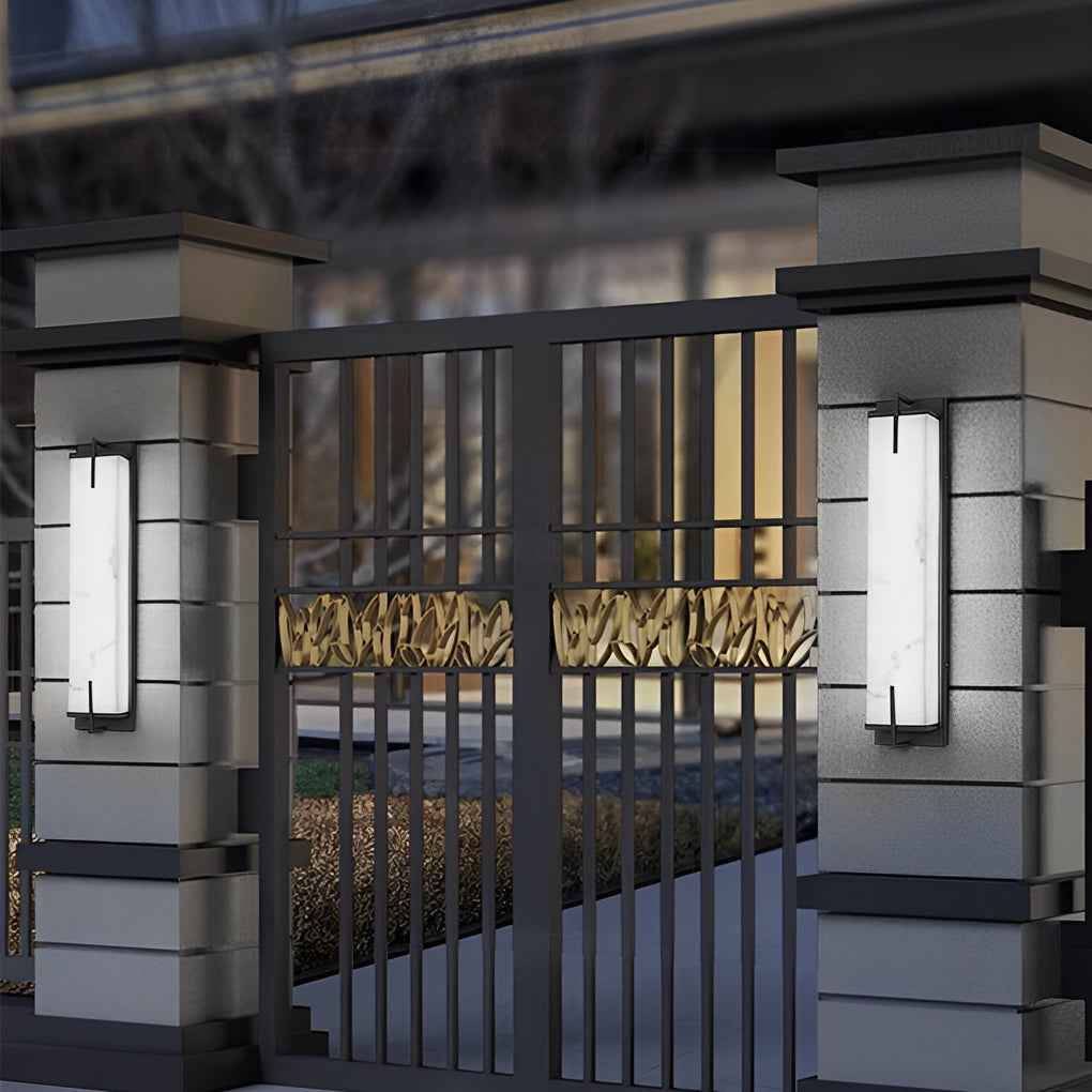 Stone wall sconce lighting on a stone wall, creating a sleek and sophisticated outdoor ambiance.