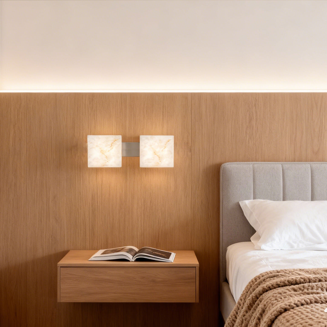 Stone wall sconce lighting mounted on rich wood paneled wall above modern bedroom with warm tones