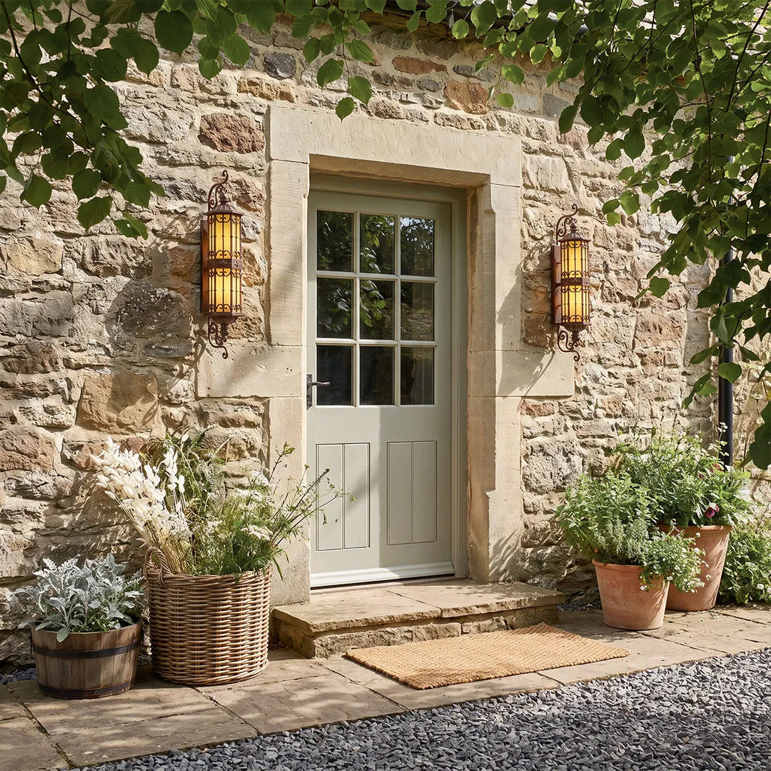 Vintage wall sconce lighting installed beside a rustic stone doorway with warm ambient light.