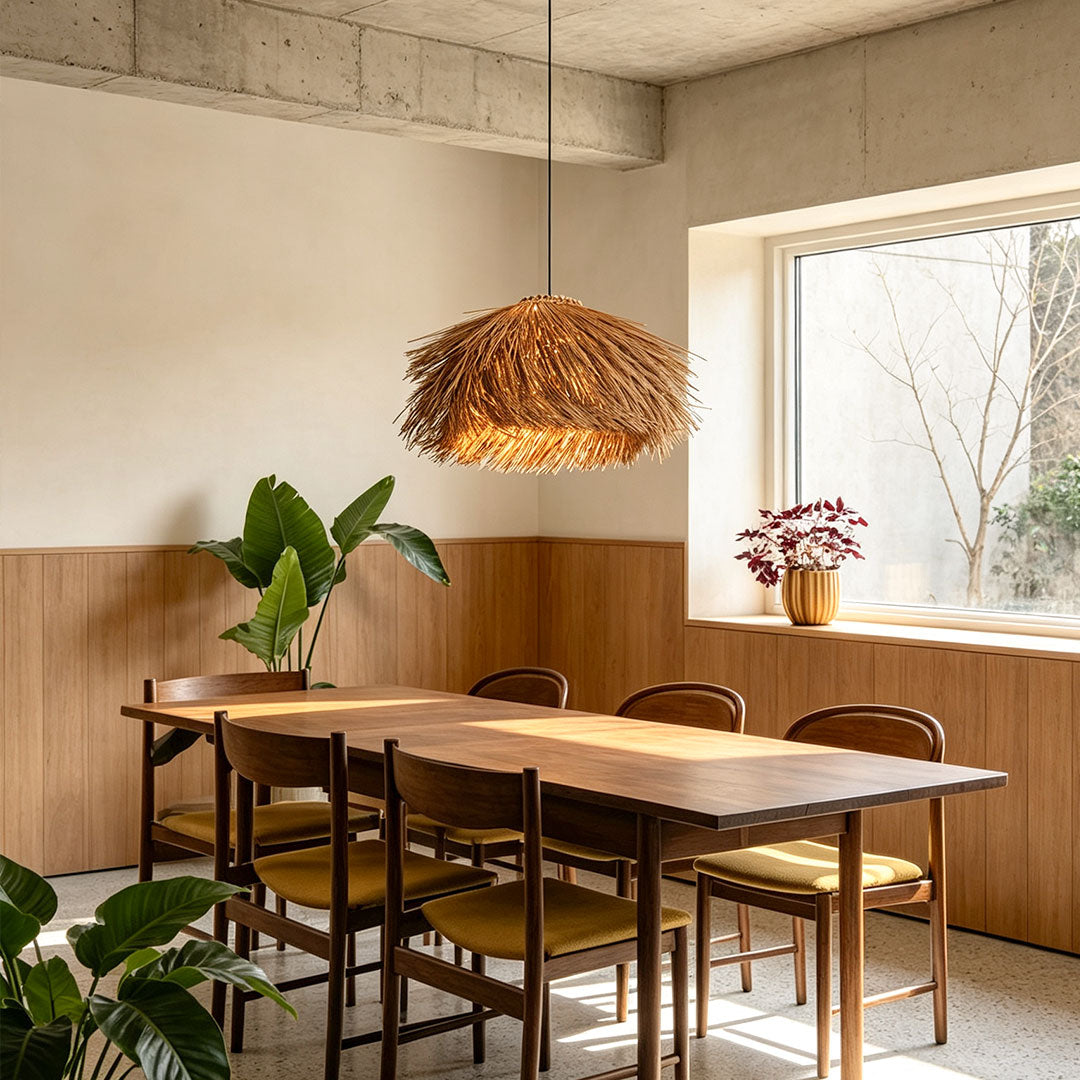 Straw pendant light installed above a wooden dining table in a modern dining room with natural finishes.