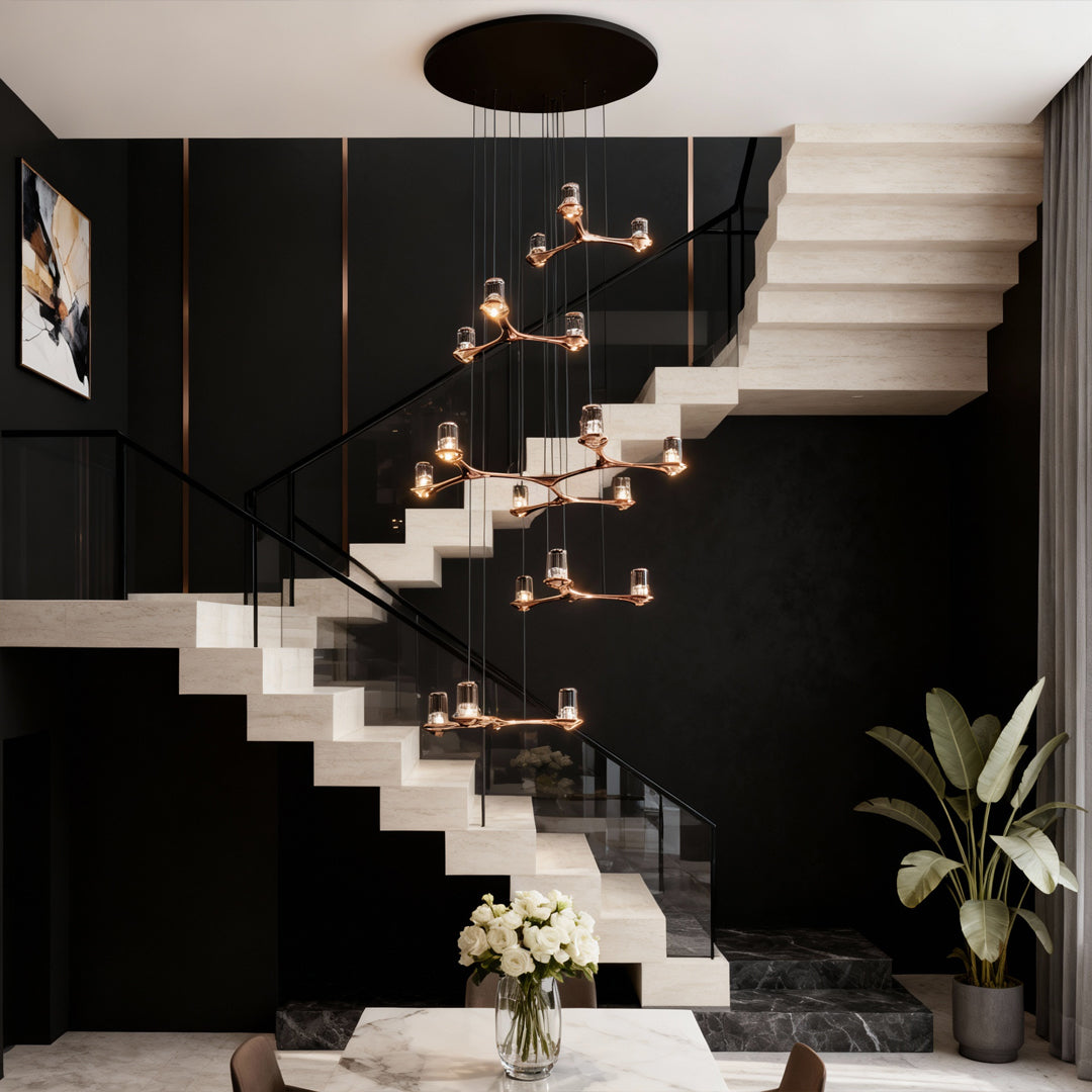 Striking crystal staircase chandelier descending along modern black and white staircase in contemporary home interior