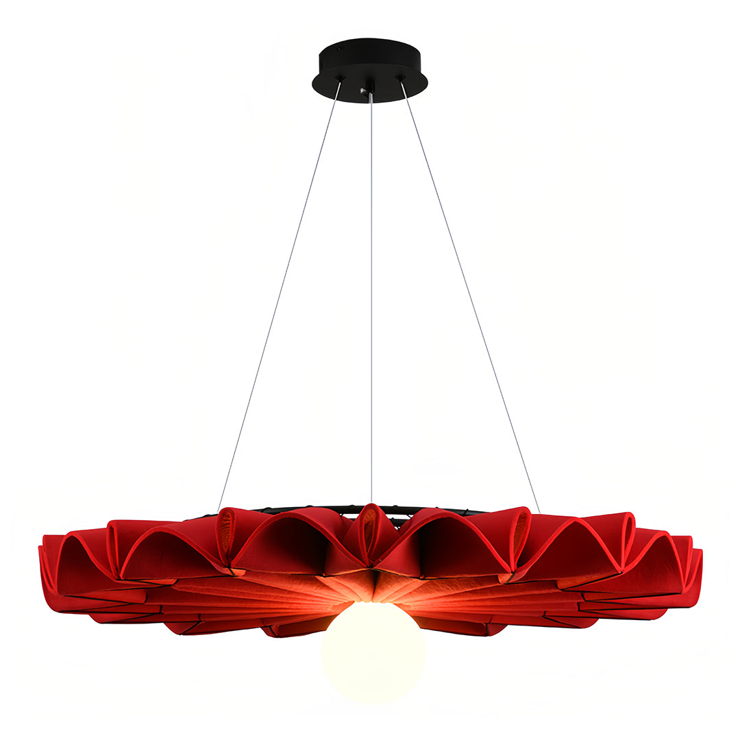 Striking red ruffled cloth chandelier casting a warm glow on the lower half of the shade 