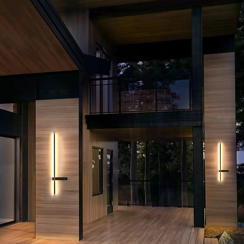 Architectural Strip Wall Lighting applied to a modern home exterior, showing a tall vertical light strip enhancing the entrance facade at night.