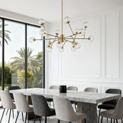 Stunning bubble sputnik chandelier with a gold finish, mounted above a fireplace in a vaulted ceiling, providing warm, diffused light.