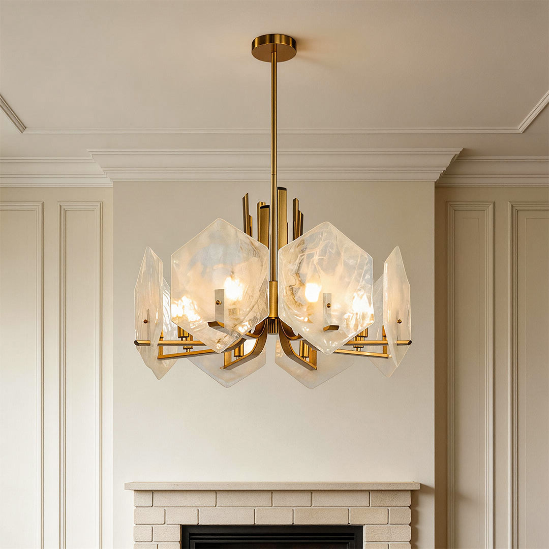 Stunning gold geometric chandelier featuring frosted alabaster-style glass panels hanging above a fireplace in an elegant room.