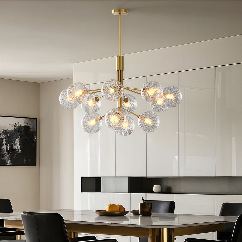 Stunning luxury modern chandeliers with multiple glass spheres, hanging above a dining table in a contemporary space.