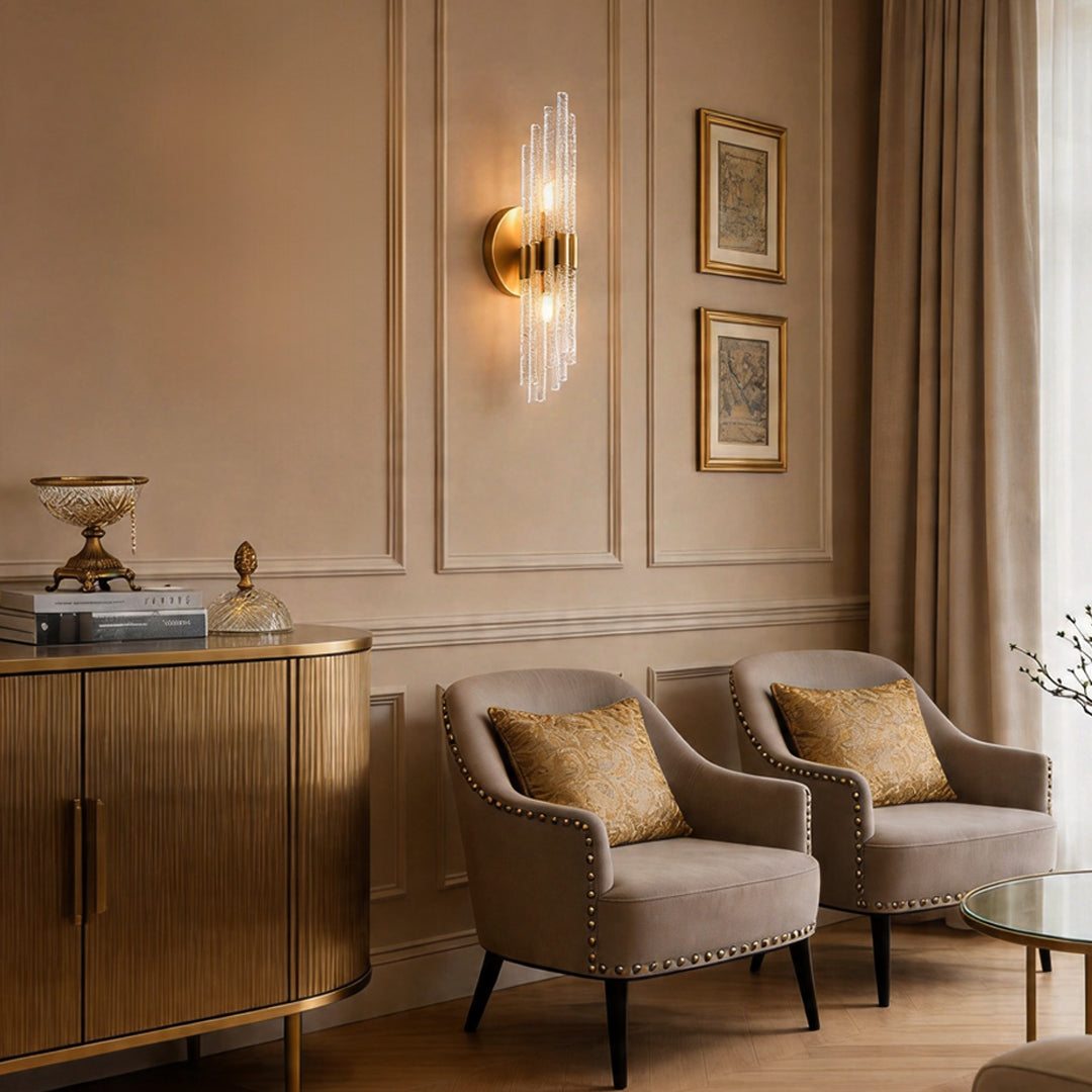 Stunning modern crystal wall light illuminating a cozy sitting nook with two beige armchairs.