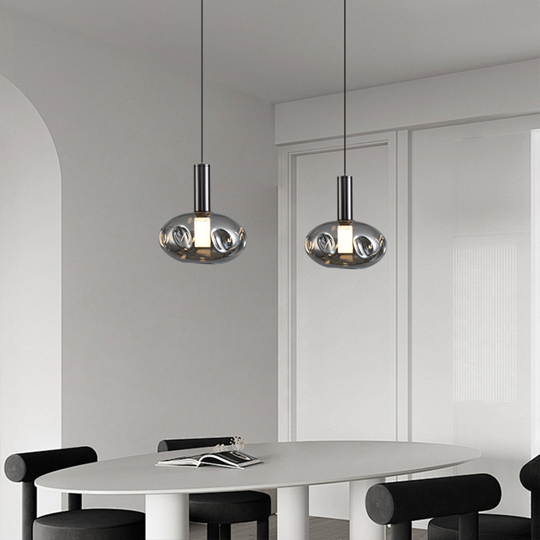 Stylish drum pendant lights positioned over bedroom area with contemporary decor